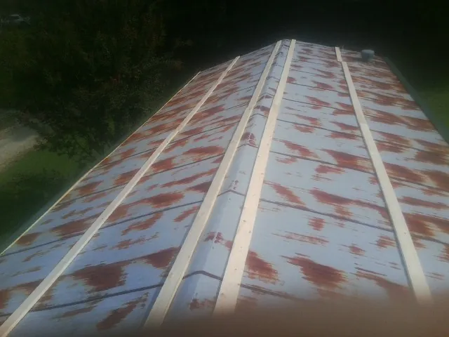 Rusted metal roof panels with new wood purlins before replacement — Storm Damage Roof Repair in Gravity by Roofing Brothers
