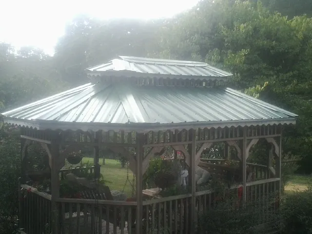 Two tier green metal roof on a garden gazebo in Gravity